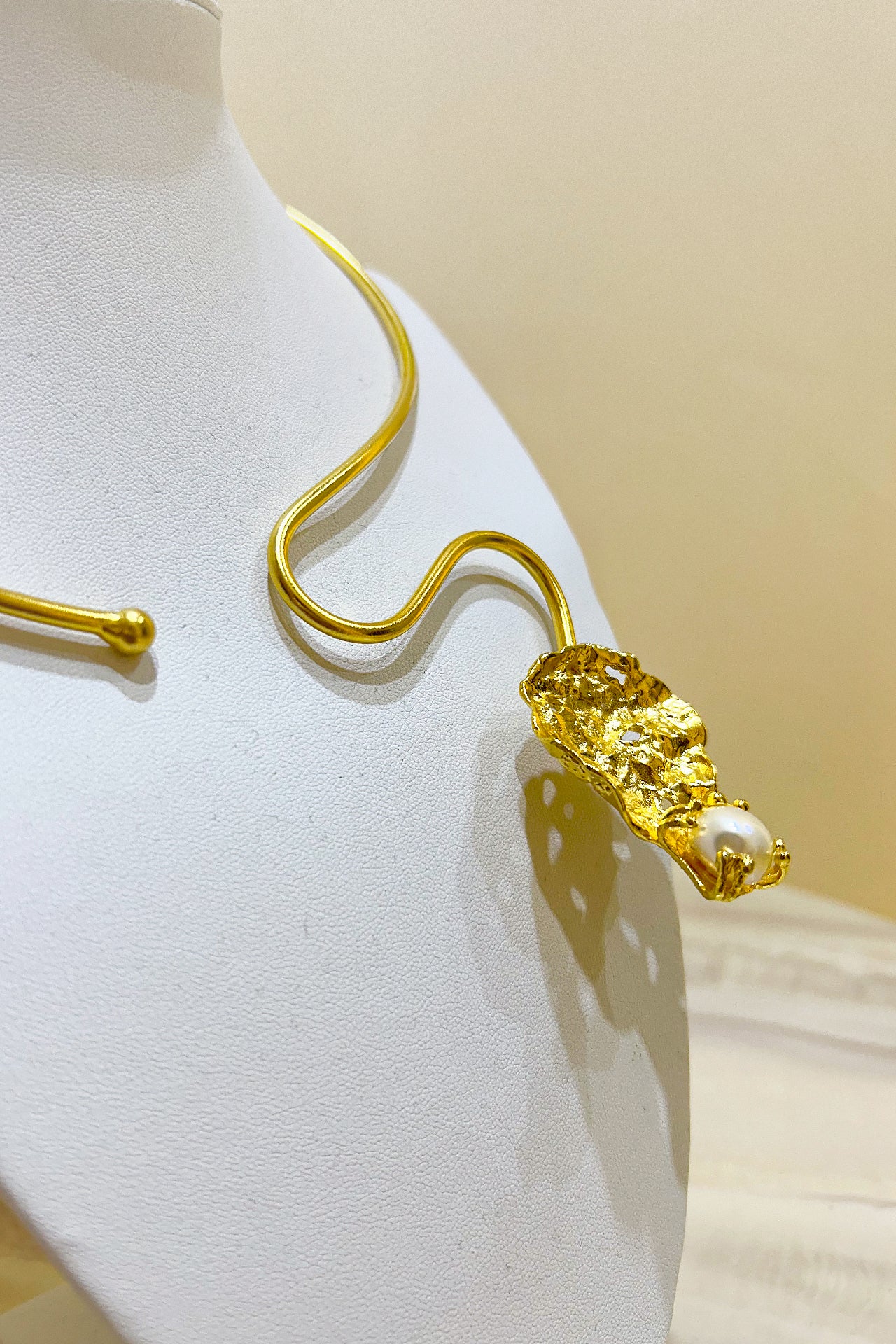 Gold Curved Leaf Necklace by M Collection